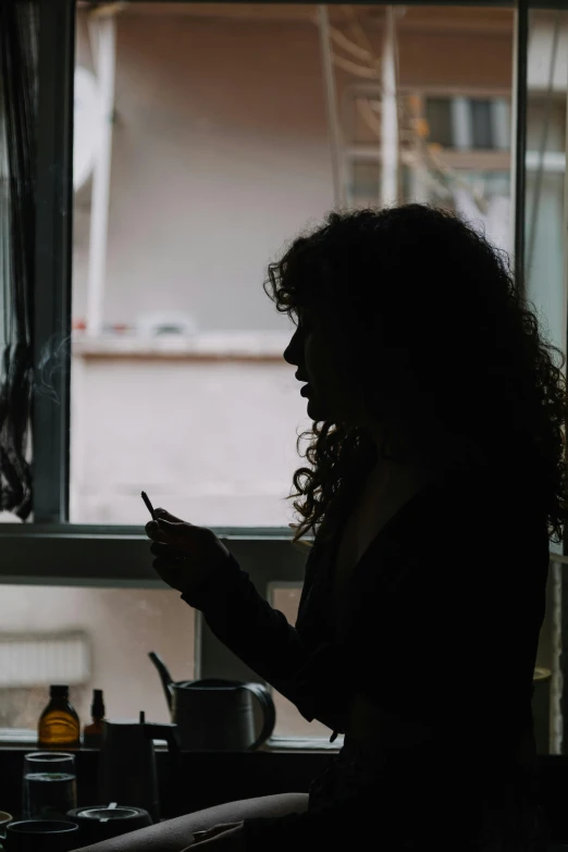 a woman that is sitting down with a cellphone