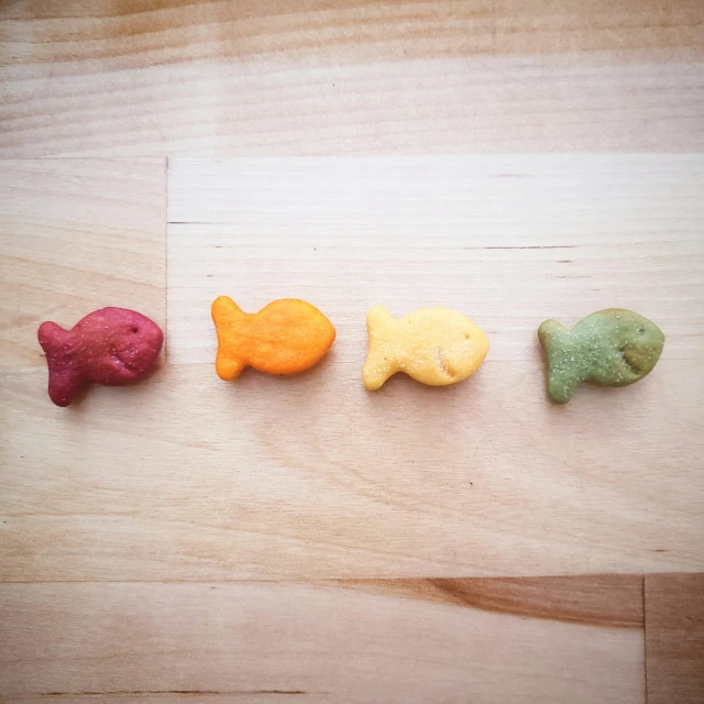 four different types of food shaped like fish