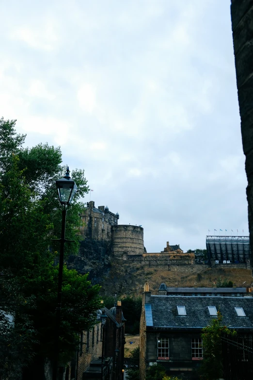 a tower on top of a building, next to a bunch of trees