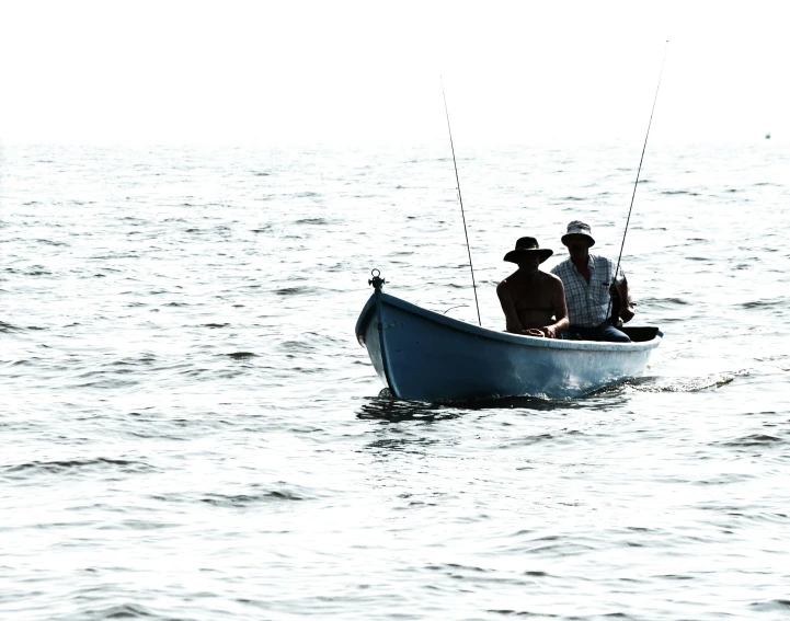 a group of men in a rowboat on the water