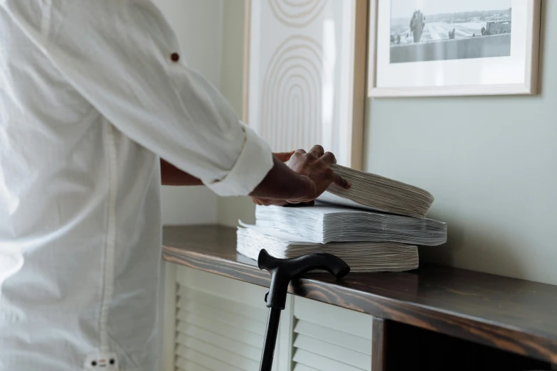 a person standing next to a books on a shelf