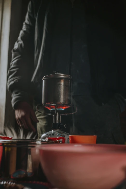 a man is standing in front of a glass bowl