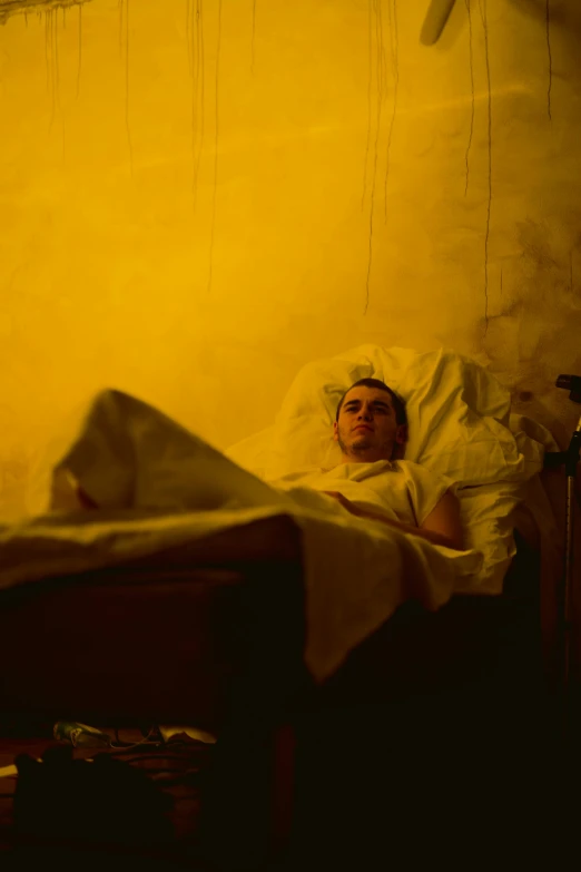 a person in a bed with some wires hanging from it