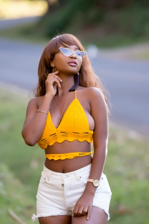 a woman in yellow  top with sunglasses on