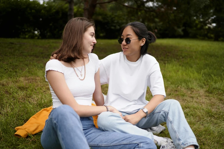 two young ladies are on a grassy field