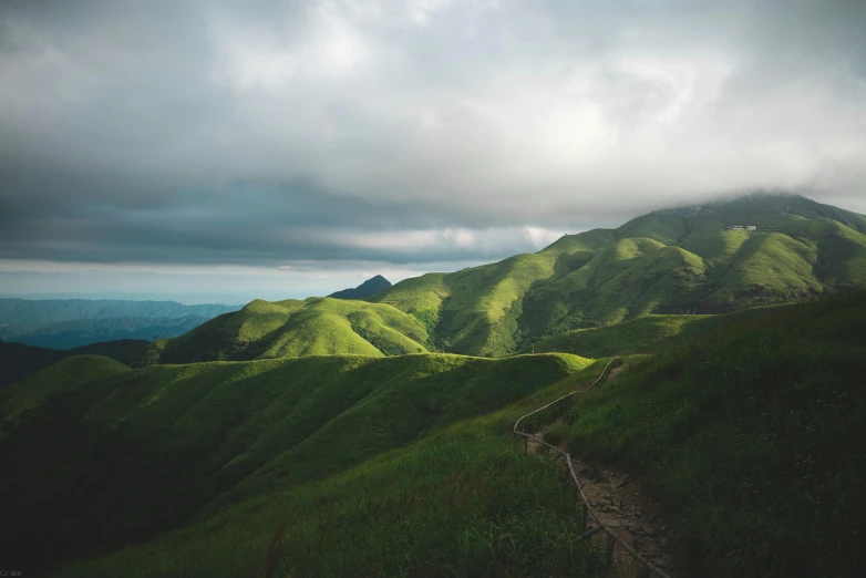 the mountains are lush and green in a cloudy day