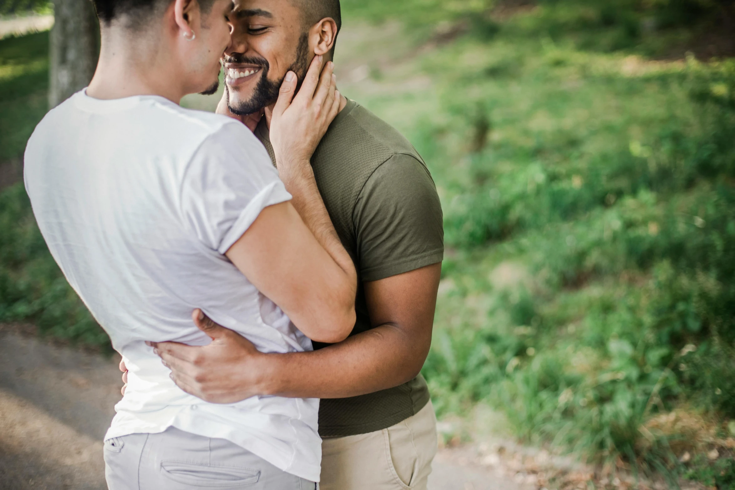 a man that has a beard holding another man