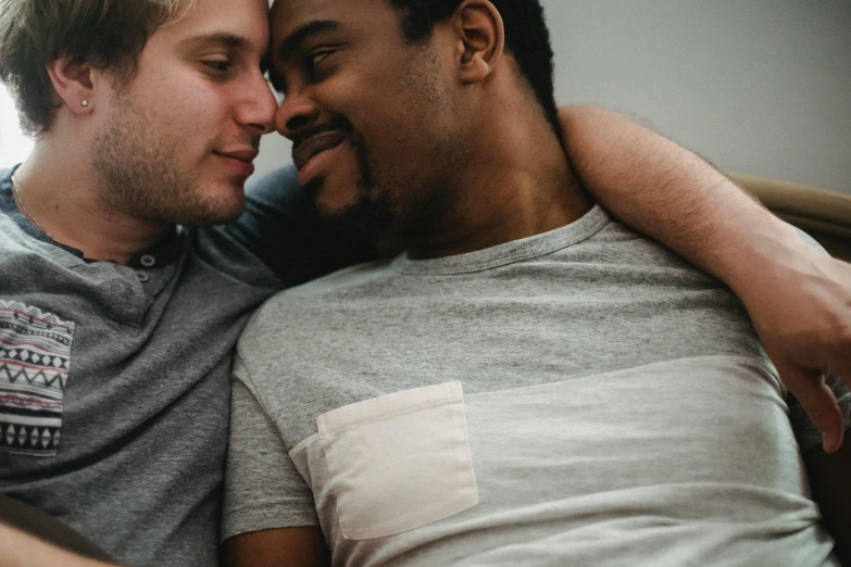 two men with each other on the same couch