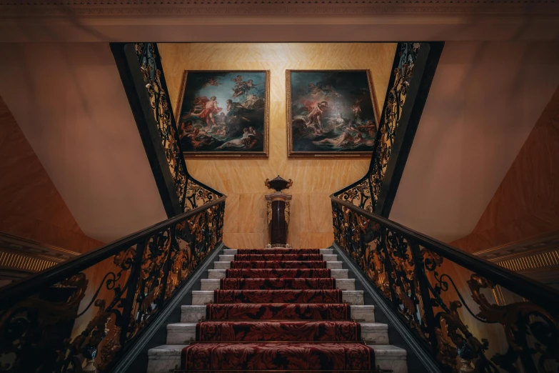 some stairs and paintings next to each other