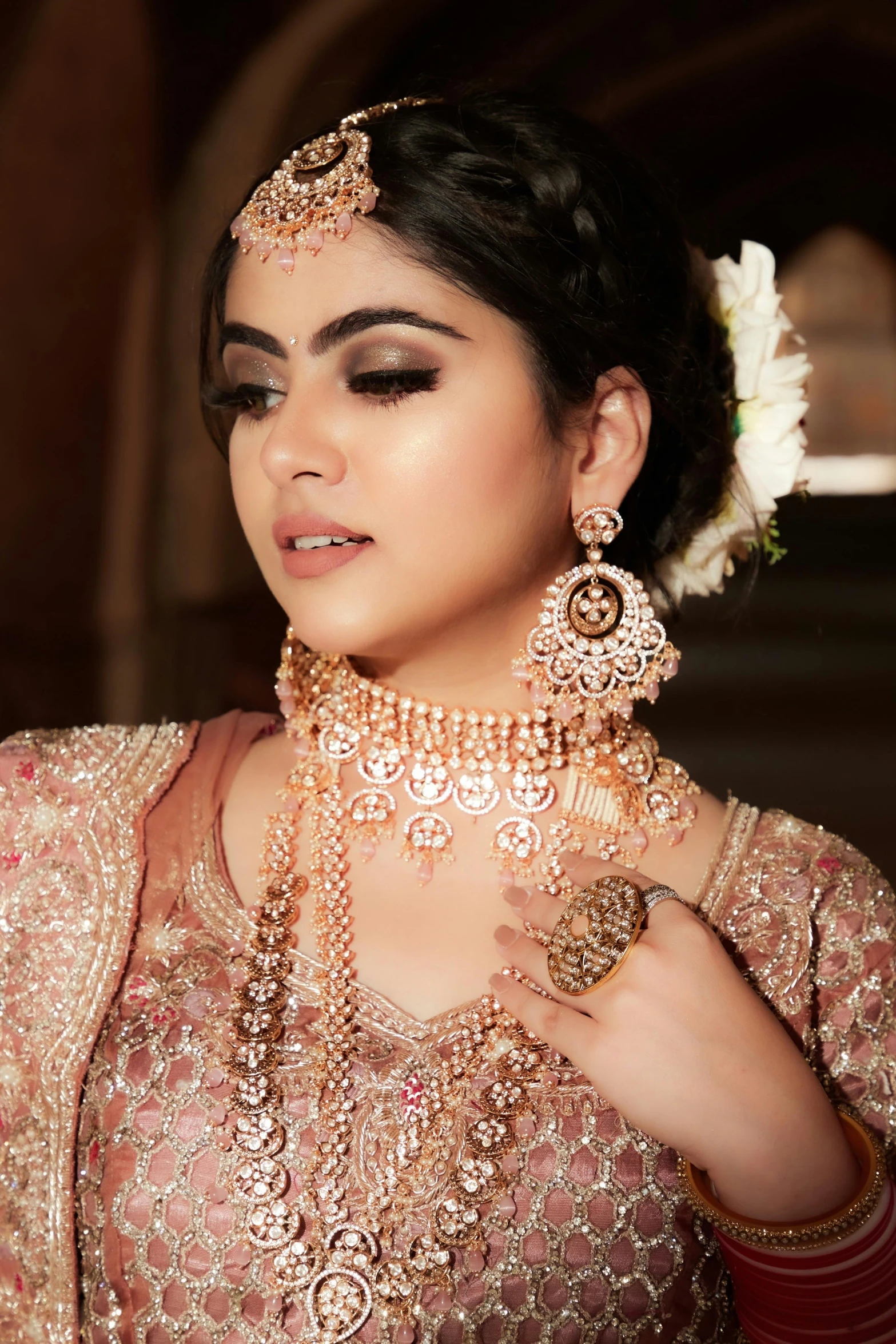 woman wearing ethnic wedding jewelry posing for a pograph