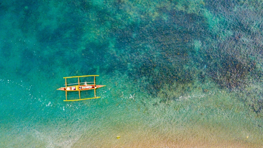 a small boat floating on top of a large body of water