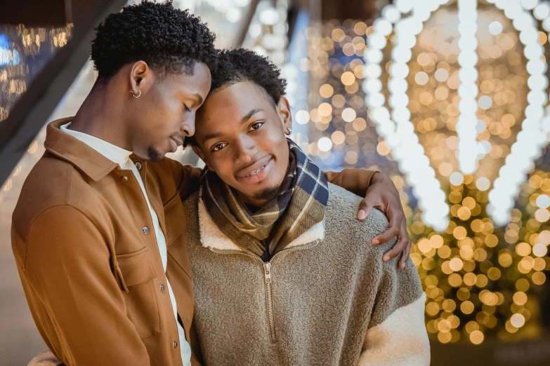 a couple emcing in front of a christmas tree