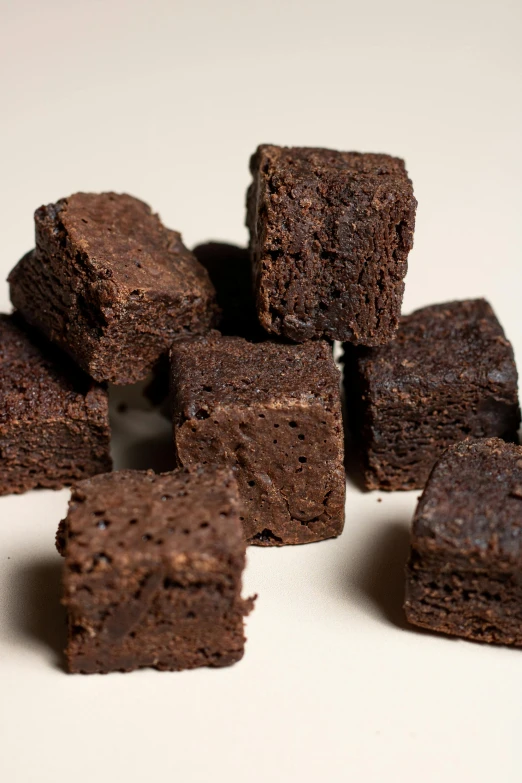 a pile of brownies sitting on top of a white table