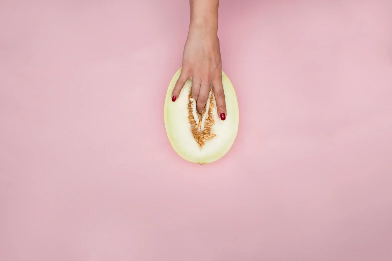 a female's hand holding an egg shell