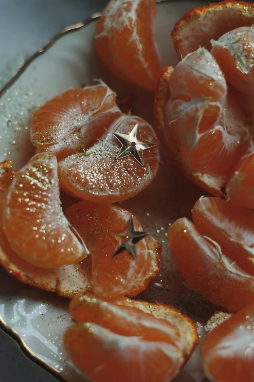 some orange slices are on the plate with star decorations