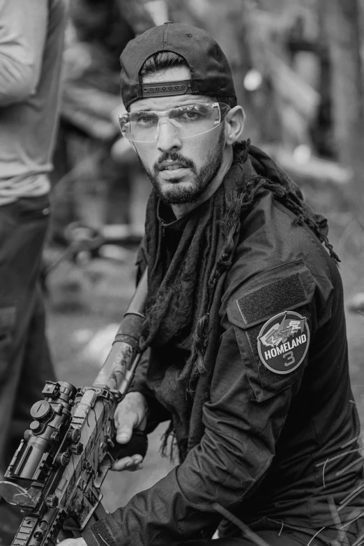 a man in black and white sitting on a motorcycle