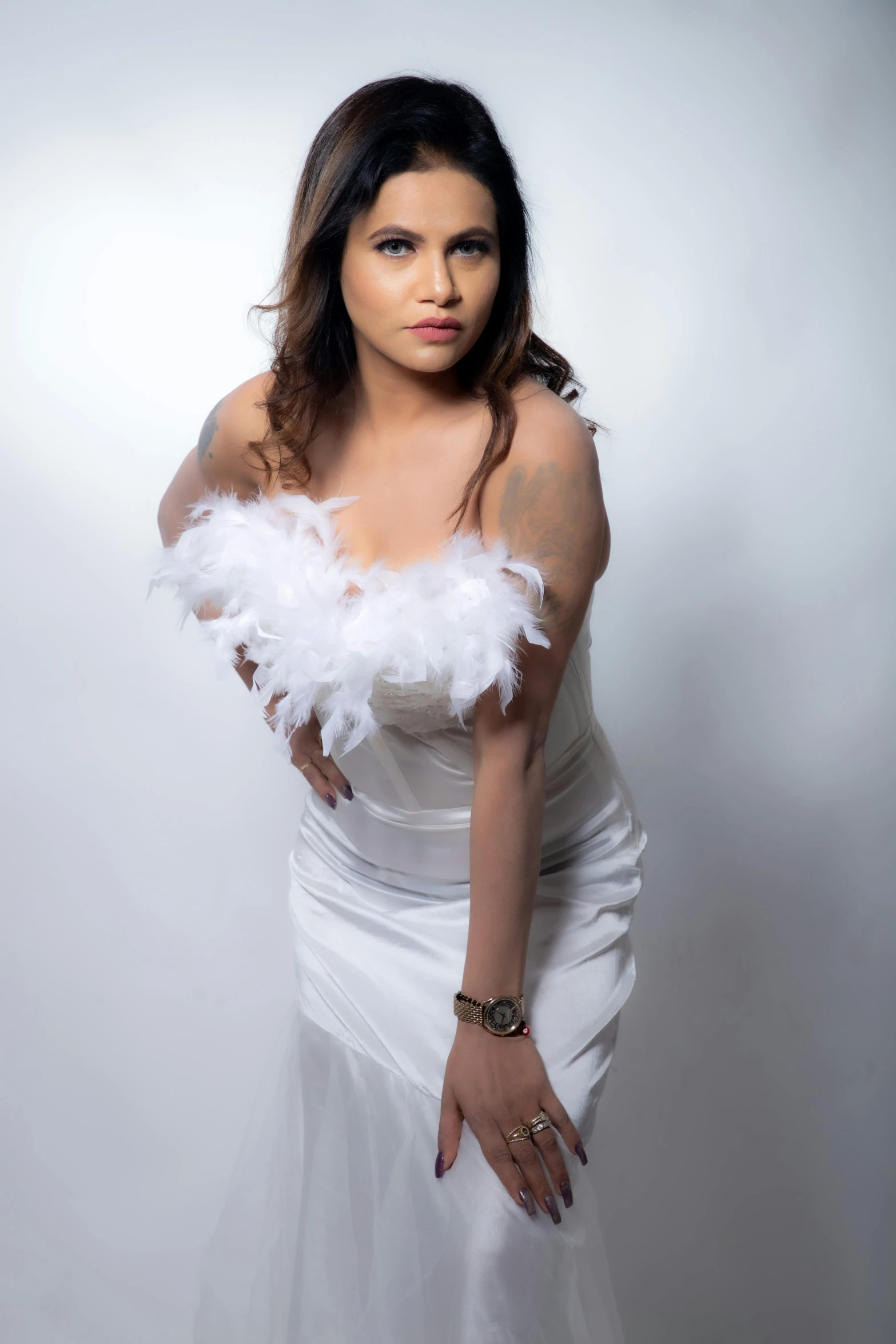 a woman in a white dress holding a white feather