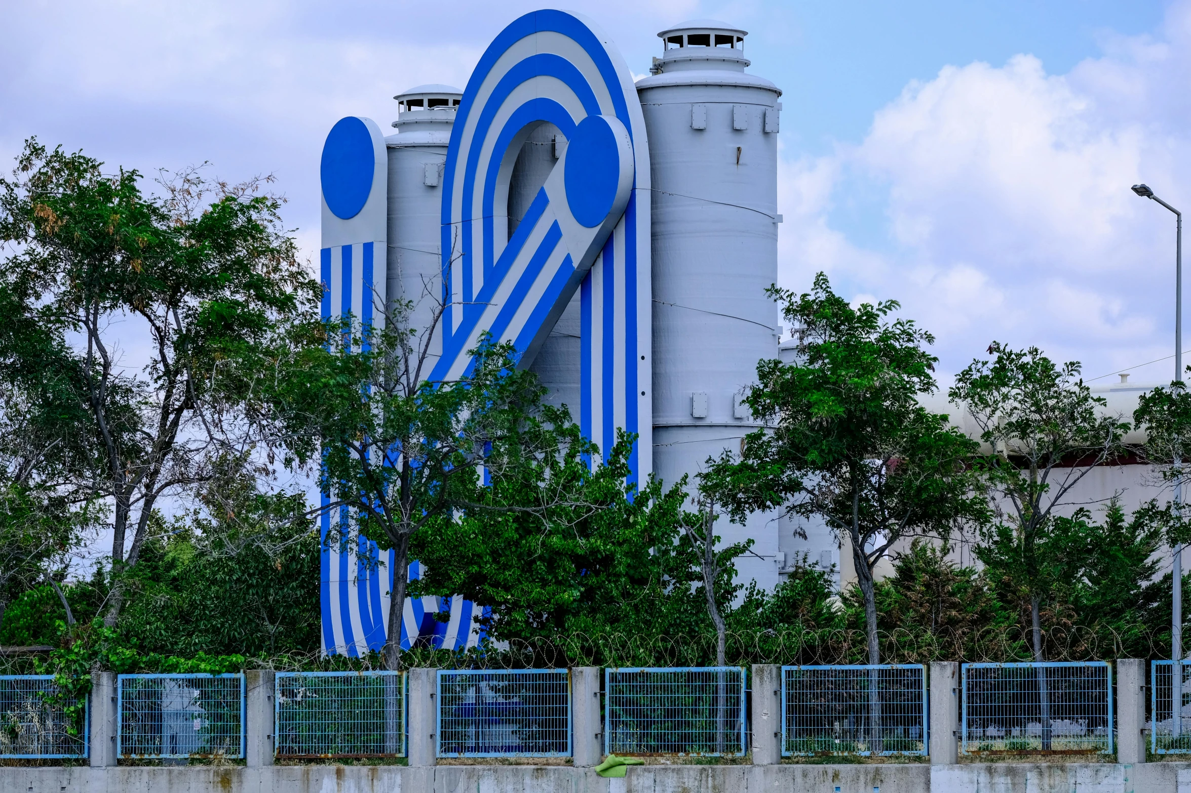 blue and white building with trees surrounding it