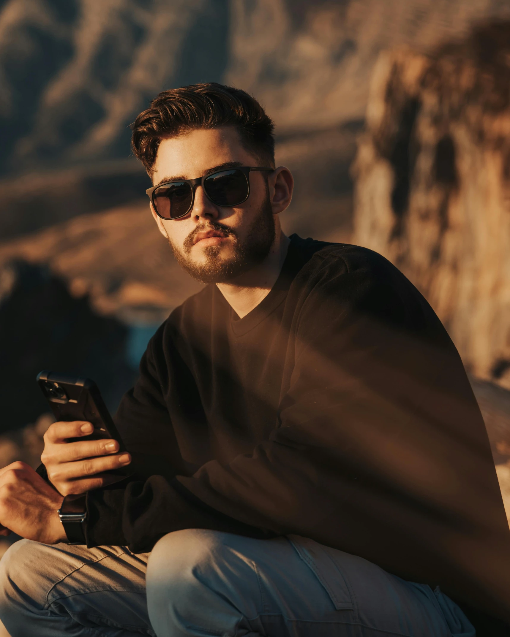 a man in sunglasses looking at his cell phone