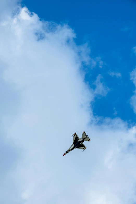 an airplane flies in the sky with clouds