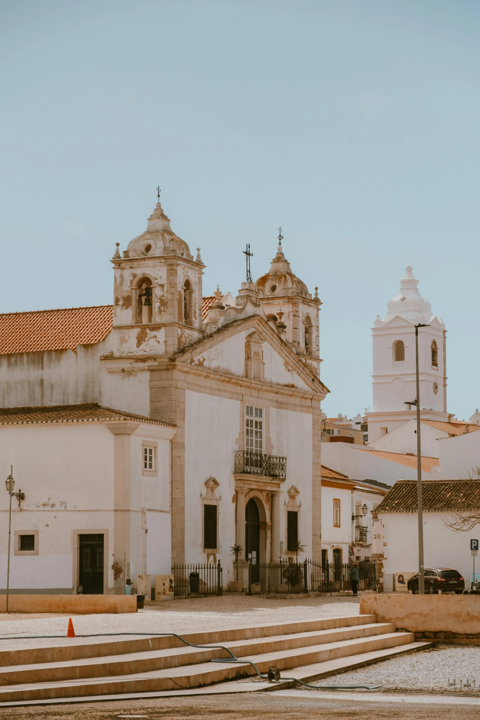 an old white building with three towers and a steeple