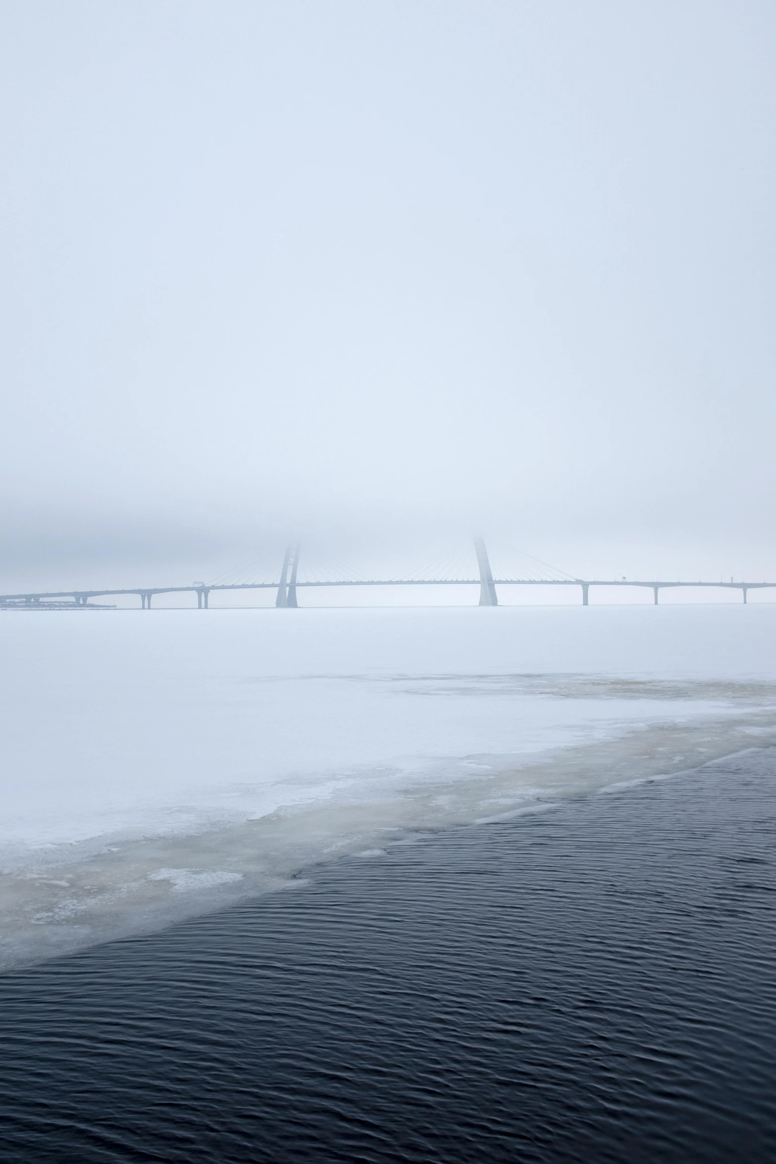 two planes flying in a snowy sky over water