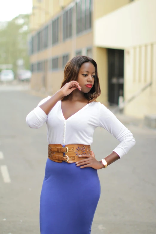 a woman in blue and white dress is posing for the camera