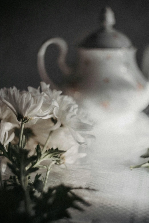 flowers in white vases with one green leaf sitting next to the other