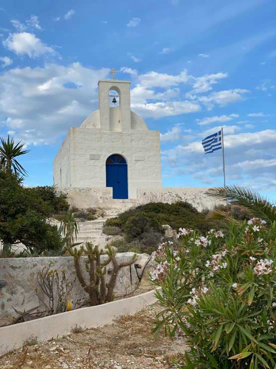 a church on a hill in front of a blue door