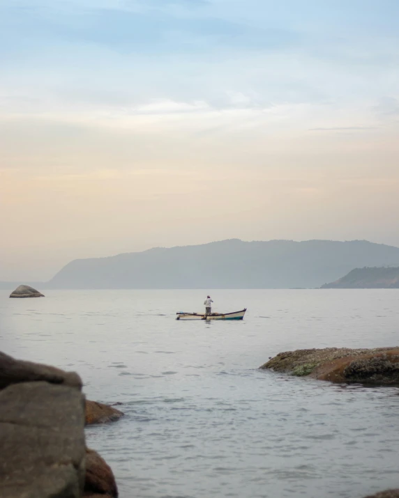 a boat is traveling across the water by the shore