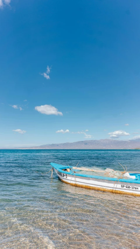 an abandoned boat on a beach with no people around