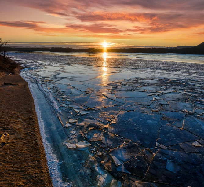 the sun setting over a body of water