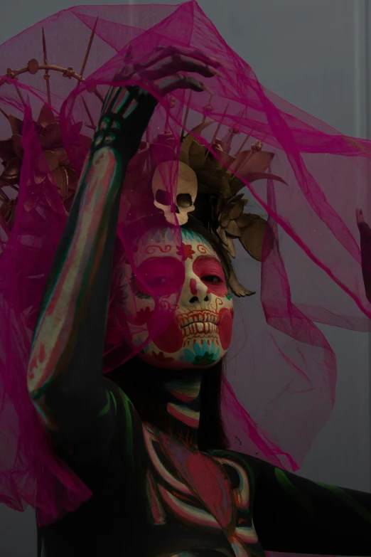 a woman with her face painted with pink tulle