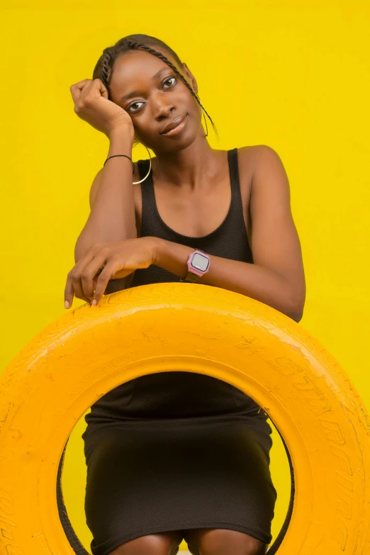 a woman posing next to a frisbee with one arm on the other