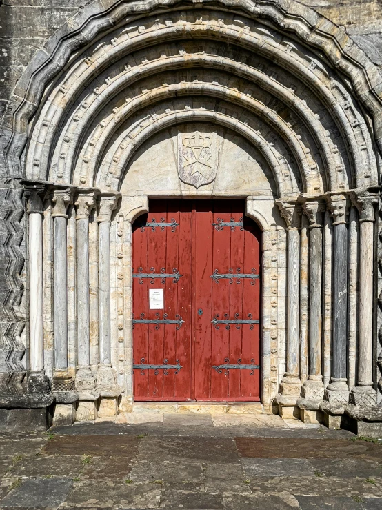 a red door sitting on top of a stone building