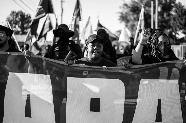 people holding banners at an outdoor sporting event