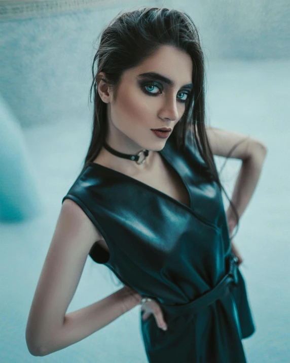 a young woman in a black leather dress