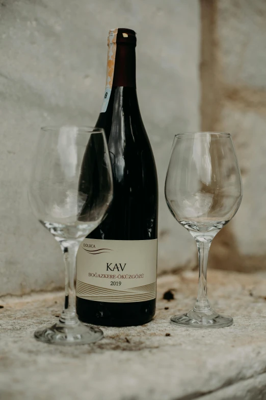 a bottle and two glasses sitting on a table