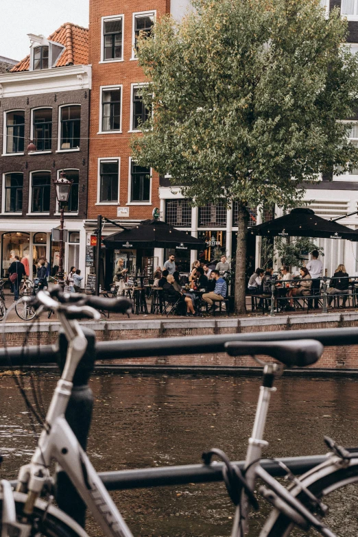 a bicycle is parked near the water in a city