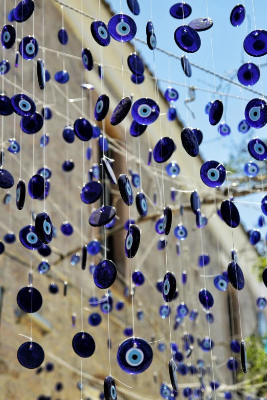 a display of glass evil eye beads hanging from a wire