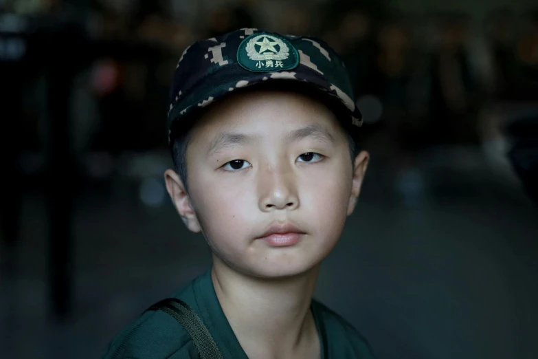 a boy in a hat with a green shirt and tie