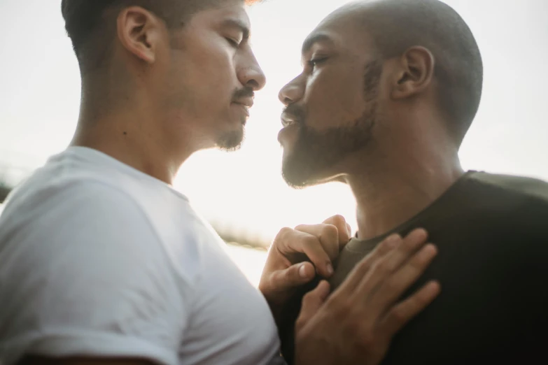 two men are facing each other as if they are kissing