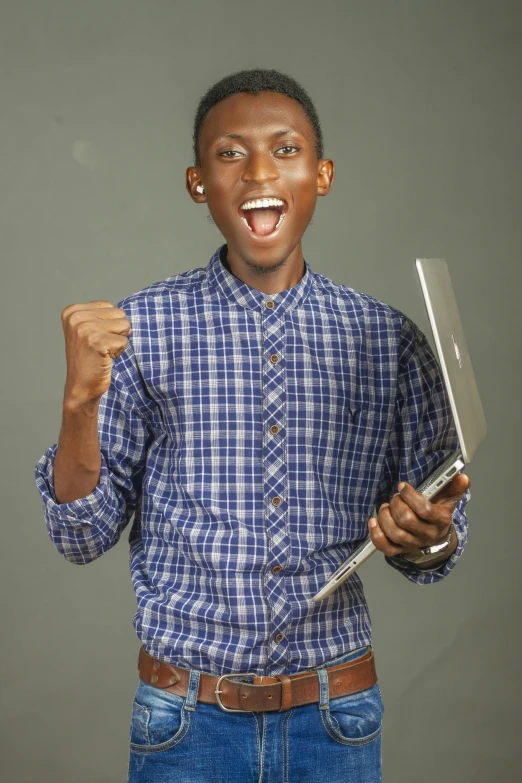 a man in jeans and a blue shirt holding a knife with one hand