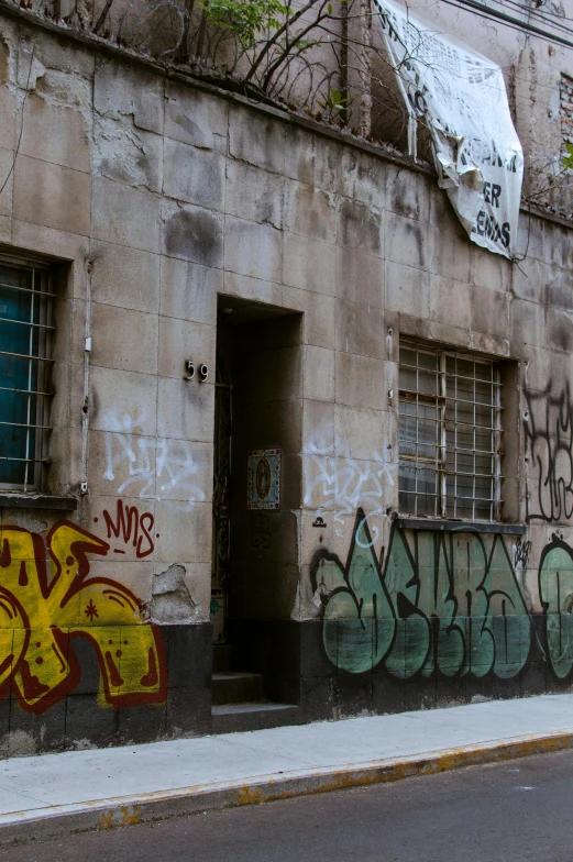 a graffiti - covered building in the french quarter of paris