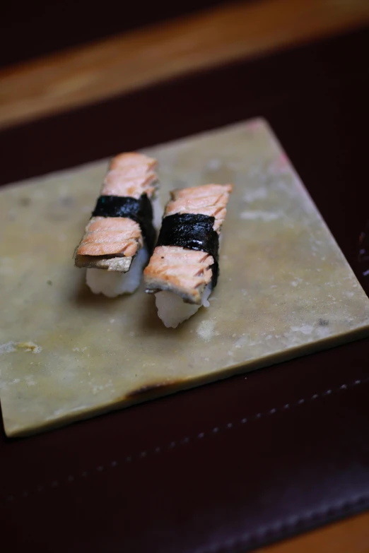 some kind of sushi dish on top of some chopping board