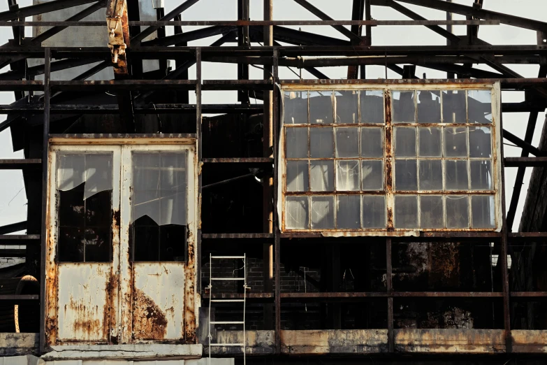 a very old building with windows and bars on the roof