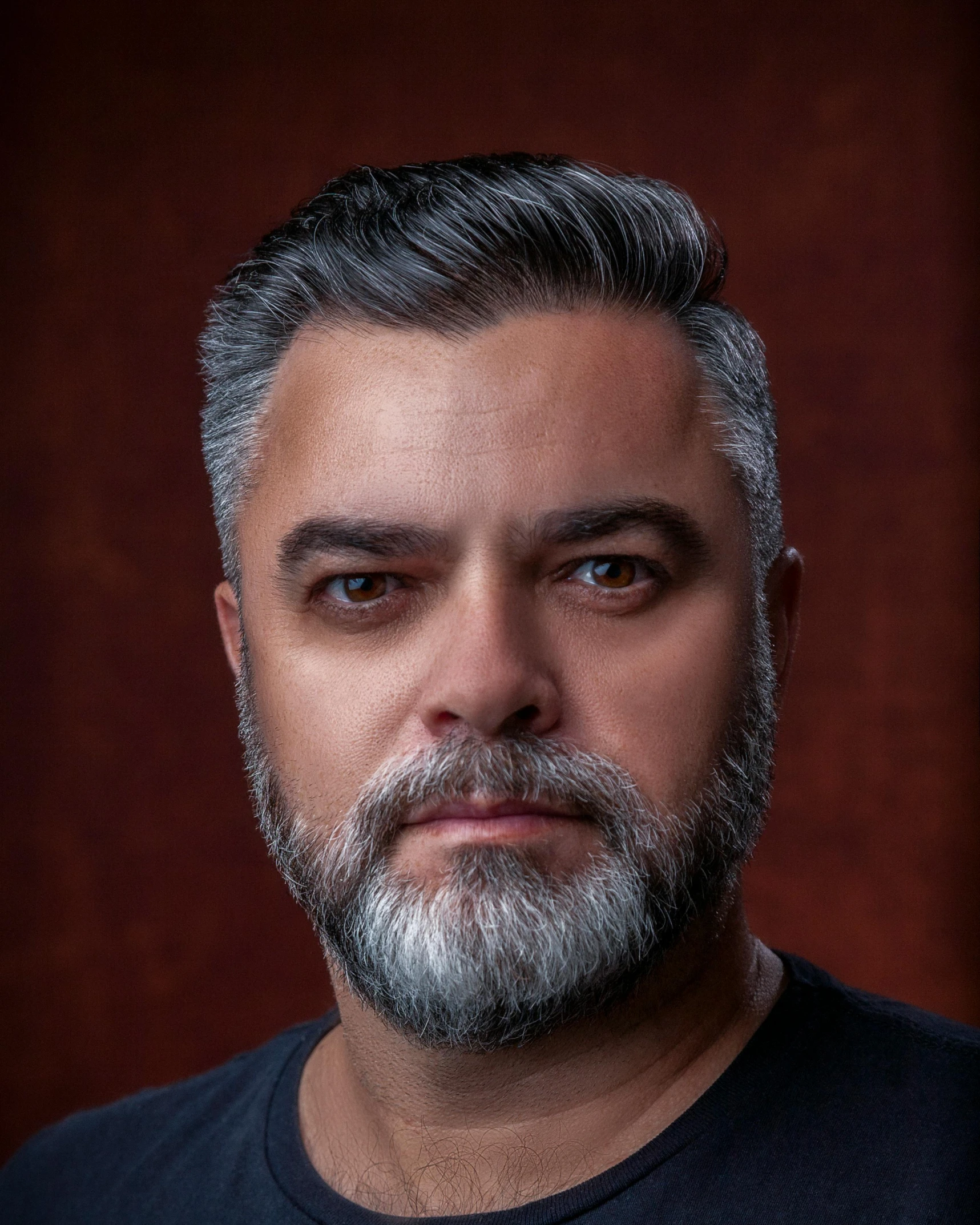 man with grey hair and beard and black shirt