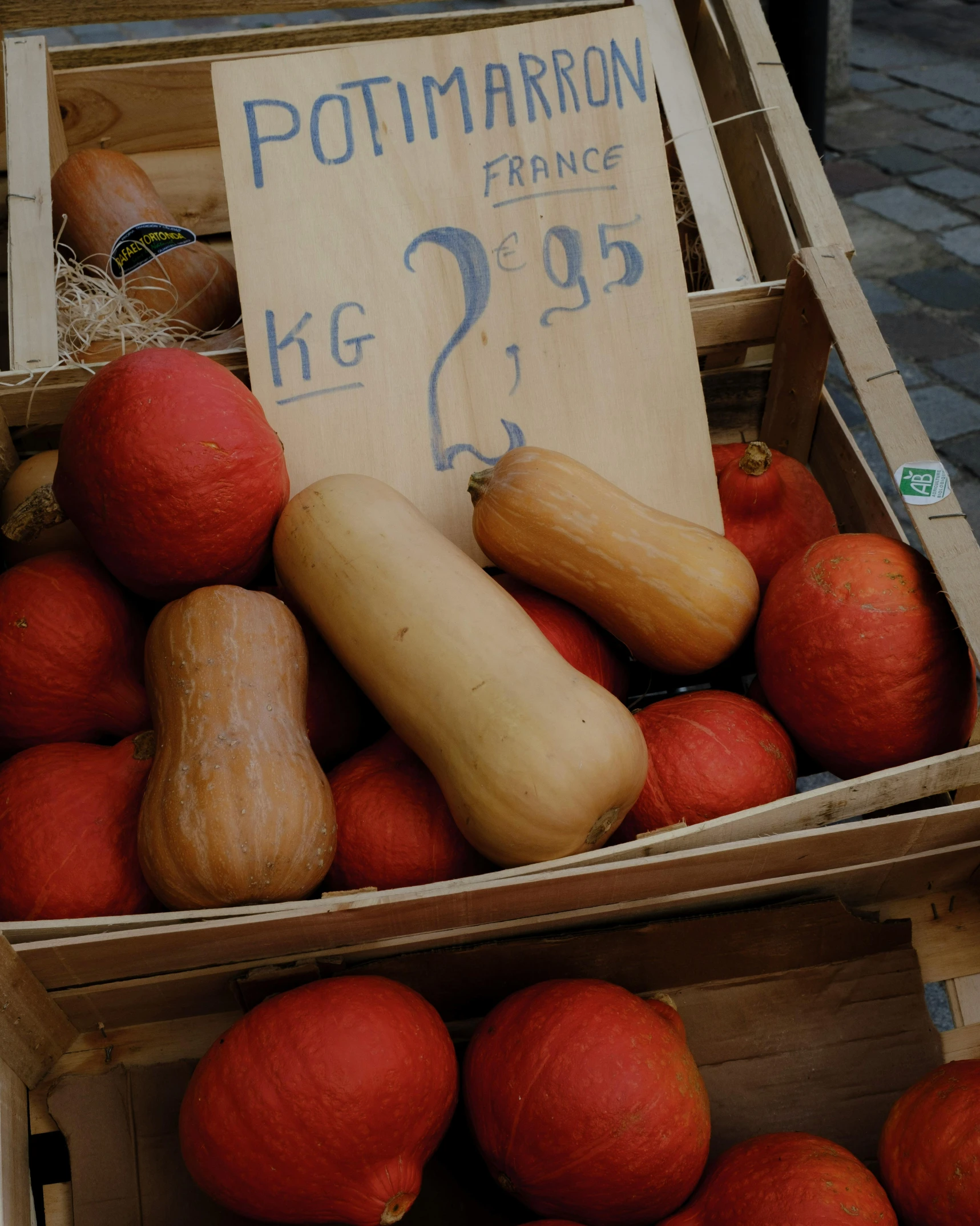 two wooden boxes full of gourds on display