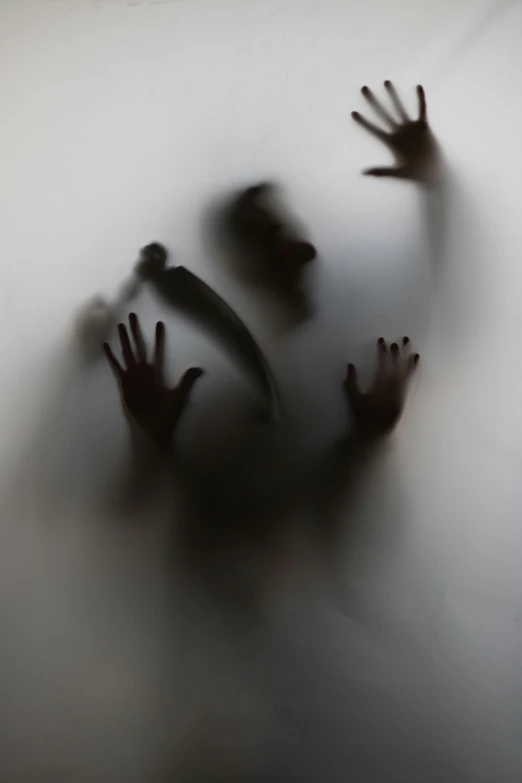 three hands coming out from the ceiling, with a person waving