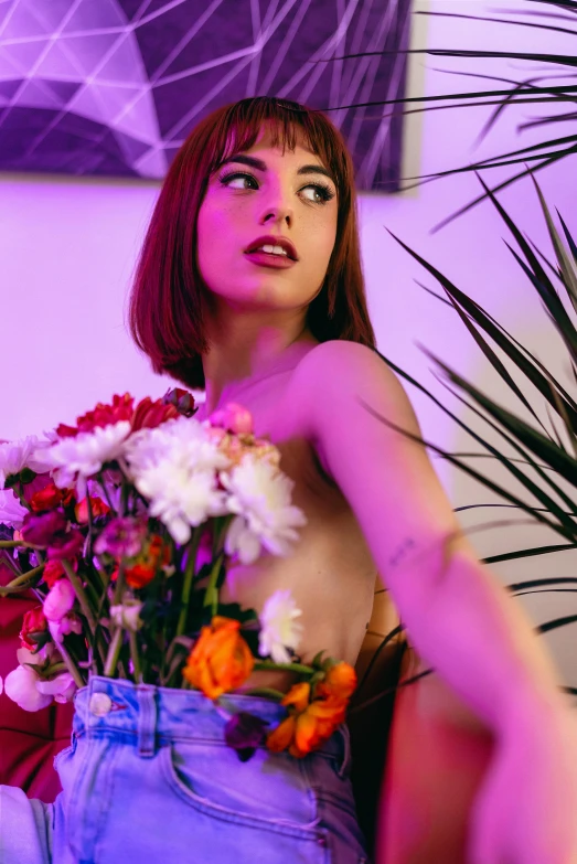  with flowers posing for camera while holding potted plant